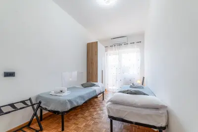 a bedroom with two beds and a window at Giorgia Flat - Tiburtina Train Station - Wi-Fi in Rome
