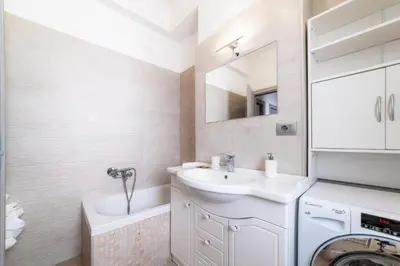a bathroom with a sink and a washing machine at Giorgia Flat - Tiburtina Train Station - Wi-Fi in Rome