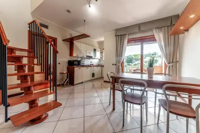 a kitchen and dining room with a table and chairs at La Terrazza sul Parco Appartamento per famiglie, Vaticano, Metro A in Rome