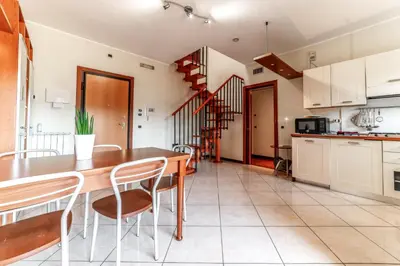 a kitchen and dining room with a wooden table and chairs at La Terrazza sul Parco Appartamento per famiglie, Vaticano, Metro A in Rome
