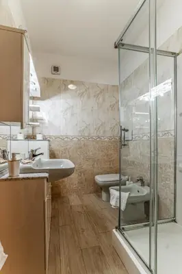 a bathroom with two sinks and a glass shower at La Terrazza sul Parco Appartamento per famiglie, Vaticano, Metro A in Rome