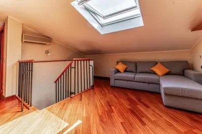 a living room with a couch and a skylight at La Terrazza sul Parco Appartamento per famiglie, Vaticano, Metro A in Rome