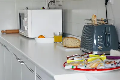 a plate of food on a counter next to a microwave at Vatican Luisa in Rome