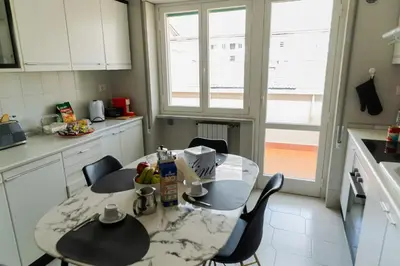 a kitchen with a table and chairs in it at Vatican Luisa in Rome