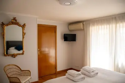 a bedroom with a bed with a mirror and a chair at Vatican Luisa in Rome