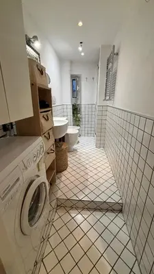 a bathroom with a washer and a sink and a toilet at Valentina Suite Colosseo in Rome