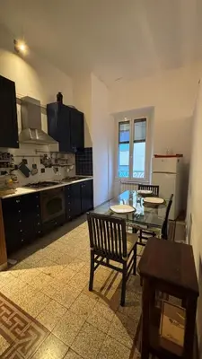 a kitchen with a table and chairs in a room at Valentina Suite Colosseo in Rome