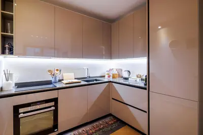 a kitchen with white cabinets and a refrigerator at Corte Trastevere Living in Rome