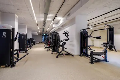 a gym with several treadmills and exercise bikes at Corte Trastevere Living in Rome