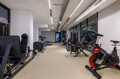 a gym with treadmills and exercise bikes in a room at Corte Trastevere Living in Rome