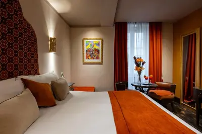 a bedroom with a large bed and a large window at HT6 Hotel Roma in Rome