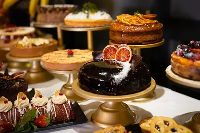 a buffet filled with different types of food on plates at HT6 Hotel Roma in Rome