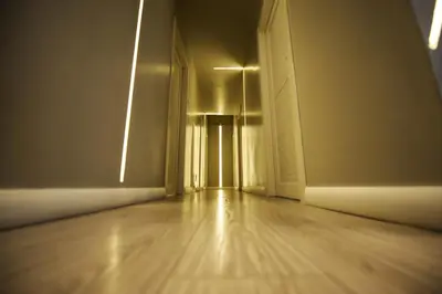 an empty room with a wooden floor and an open door at The Roman Empire Guesthouse in Rome