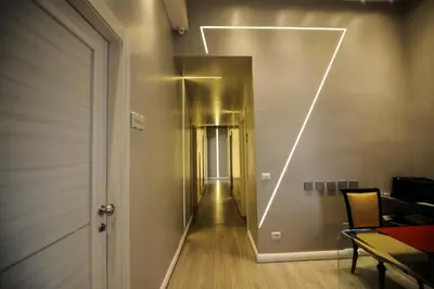 a hallway with a long hallway with a light on the wall at The Roman Empire Guesthouse in Rome