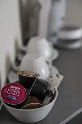 a bowl filled with cups of coffee on a counter at The Roman Empire Guesthouse in Rome