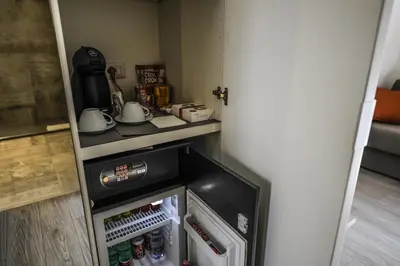 an open refrigerator with drinks in it in a room at The Roman Empire Guesthouse in Rome