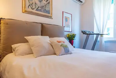 a white bed with two pillows on top of it at Casa Maria al Flaminio in Rome