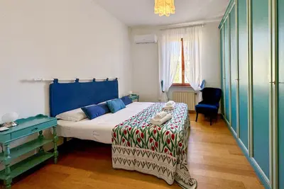 a bedroom with a bed and a chair in it at JHHIT - In the heart of Rome near the Colosseum in Rome