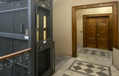 a room with a door and aoyer with a gate and a door at JHHIT - In the heart of Rome near the Colosseum in Rome