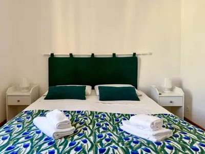 a bedroom with a bed with towels on it at JHHIT - In the heart of Rome near the Colosseum in Rome