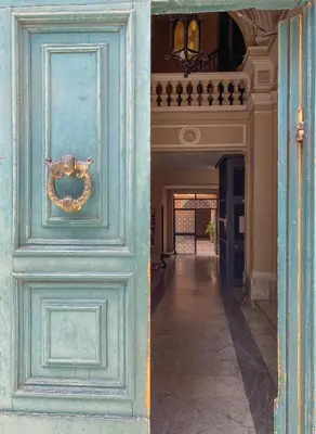 a blue door with a wreath on it in a hallway at JHHIT - In the heart of Rome near the Colosseum in Rome
