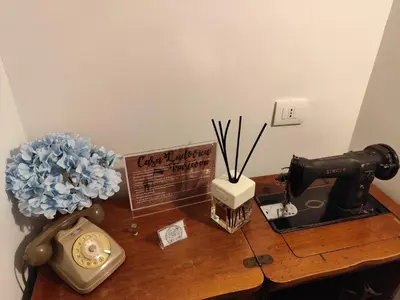 a wooden desk with a clock and a flower on it at Casa Ludovica Trastevere in Rome