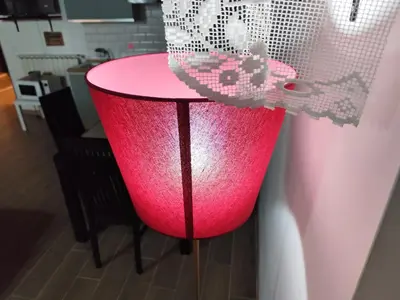 a pink table in a kitchen with a curtain at Casa Ludovica Trastevere in Rome