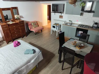 a kitchen and a living room with a table and a dining room at Casa Ludovica Trastevere in Rome