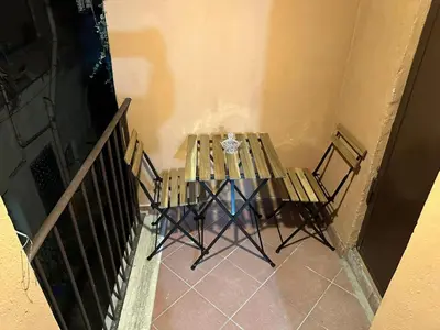 a table and two chairs in a room at Casa Ludovica Trastevere in Rome