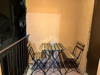 a small table and two chairs on a balcony at Casa Ludovica Trastevere in Rome