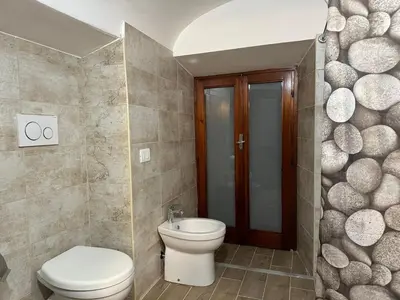 a bathroom with a toilet and a sink at Casa Ludovica Trastevere in Rome