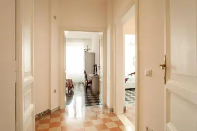a bedroom with a bed and a painting on the wall at Vatica B&B Roma in Rome