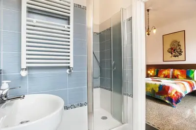 a bedroom with a bed with a colorful blanket at Vatica B&B Roma in Rome