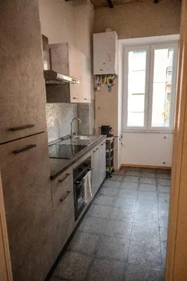 a kitchen with stainless steel appliances and a window at Home Holiday Rome - San Lorenzo in Rome
