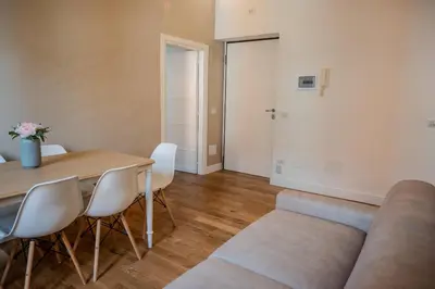 a living room with a couch and a table and chairs at Home Holiday Rome - San Lorenzo in Rome
