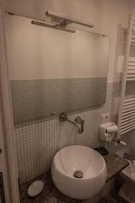 a bathroom with a white toilet and a sink at Home Holiday Rome - San Lorenzo in Rome