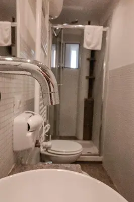 a bathroom with a toilet and a sink and a shower at Home Holiday Rome - San Lorenzo in Rome