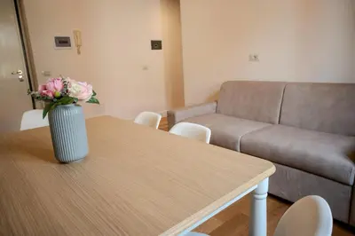 a living room with a table with a vase of flowers on it at Home Holiday Rome - San Lorenzo in Rome