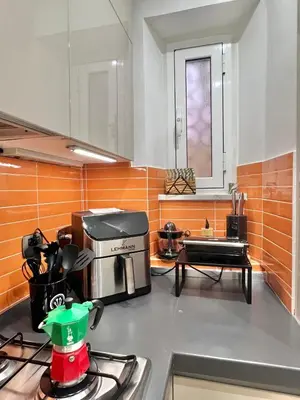 a kitchen with a counter with a coffee maker on a stove at Granma Apt in Rome