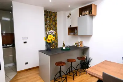 a kitchen with a bar with stools and a table at Granma Apt in Rome