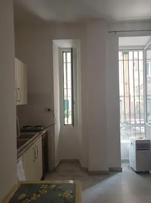 a kitchen with white walls and a door to a window at Monolocale vicino metro Libia in Rome