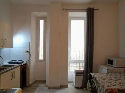 a kitchen with a bed and a window in a room at Monolocale vicino metro Libia in Rome