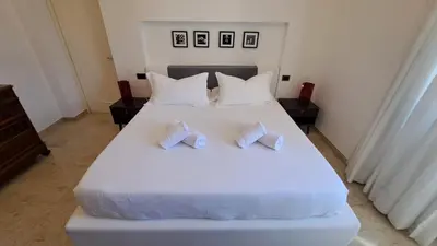 a bedroom with a white bed with two pillows at Elegante Appartamento Vaticano Lattanzio in Rome
