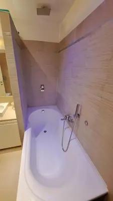 a bath tub with a shower in a bathroom at Elegante Appartamento Vaticano Lattanzio in Rome