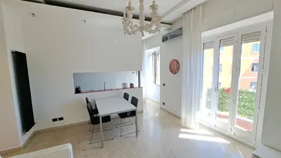 a dining room with a table and chairs and a chandelier at Elegante Appartamento Vaticano Lattanzio in Rome