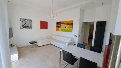 a living room with a white couch and a table at Elegante Appartamento Vaticano Lattanzio in Rome