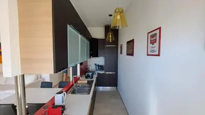 a room with a hallway with a kitchen and a tv at Elegante Appartamento Vaticano Lattanzio in Rome