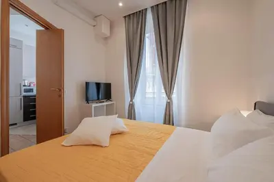 a bedroom with a large bed with a television on it at Happy Home in Rome