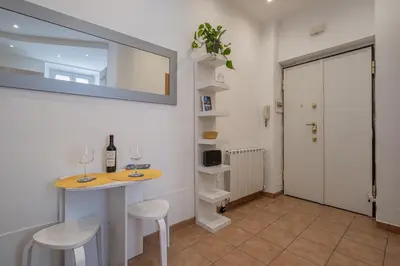 a room with a table and two chairs and a mirror at Happy Home in Rome