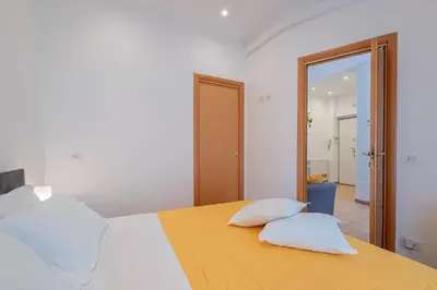 a bedroom with a bed with two pillows on it at Happy Home in Rome
